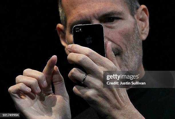 Apple CEO Steve Jobs demonstrates the new iPhone 4 as he delivers the opening keynote address at the 2010 Apple World Wide Developers conference June...