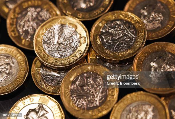 Collection of one pound sterling coins sit in this arranged photograph in London, U.K., on Wednesday, Aug. 15, 2018. The pound's weakness is turning...