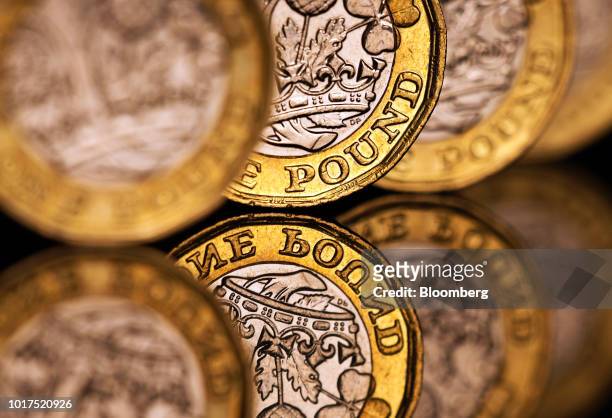 Row of one pound sterling coins stand in this arranged photograph in London, U.K., on Wednesday, Aug. 15, 2018. The pound's weakness is turning...