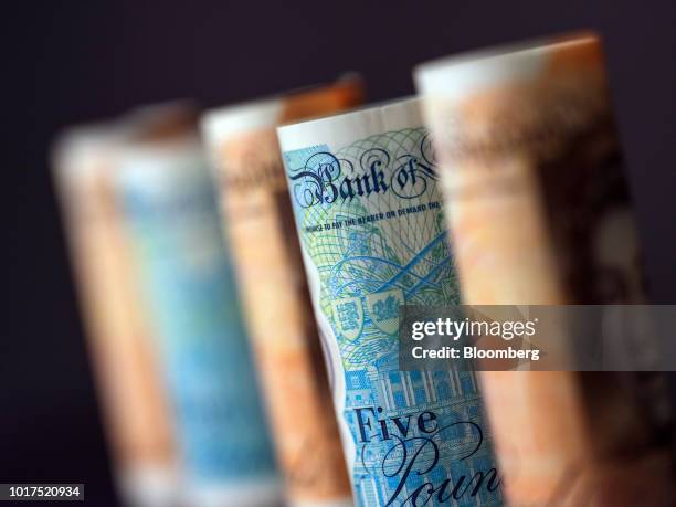 British 10-and five pound banknotes stand in this arranged photograph in London, U.K., on Wednesday, Aug. 15, 2018. The pound's weakness is turning...