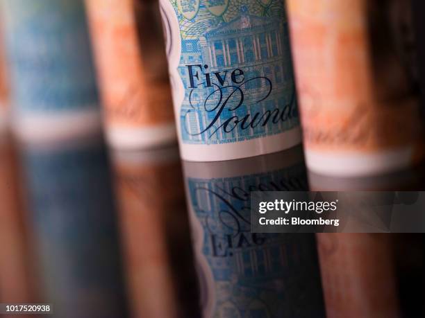 British 10-and five pound banknotes stand in this arranged photograph in London, U.K., on Wednesday, Aug. 15, 2018. The pound's weakness is turning...