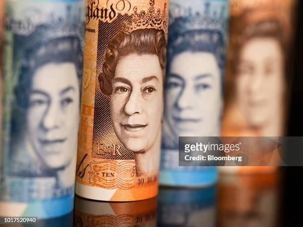 The image of Queen Elizabeth II sits on British 10 and five pound banknotes in this arranged photograph in London, U.K., on Wednesday, Aug. 15, 2018....