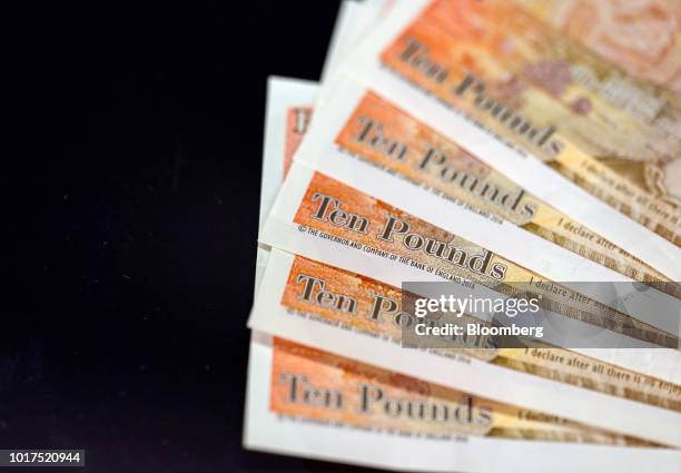 Collection of British 10-pound banknotes sit in this arranged photograph in London, U.K., on Wednesday, Aug. 15, 2018. The pound's weakness is...