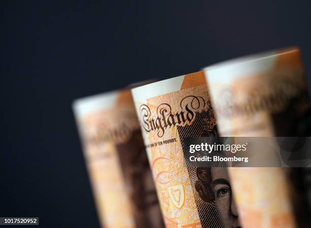 British 10-pound banknote stand in this arranged photograph in London, U.K., on Wednesday, Aug. 15, 2018. The pound's weakness is turning...