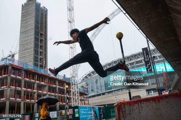 Parkour practitioner jumps off a concrete block during a photocall to promote the 'International Parkour Gathering XIII 2018' at Wembley Stadium on...