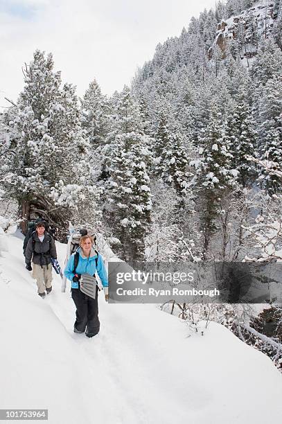 a couple backpacks through the snow in diamond fork, springville, utah. - springville utah stock pictures, royalty-free photos & images