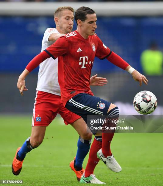 Lewis Holtby of Hamburg is challenged by Sebastian Rudy of Muenchen during the friendly match between Hamburger SV and Bayern Muenchen at...