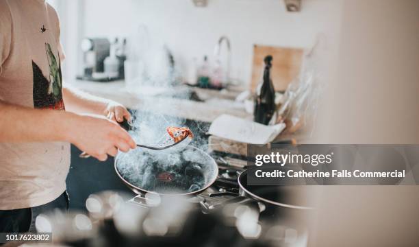 man cooking breakfast - bacon stock pictures, royalty-free photos & images