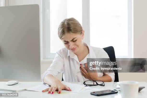 young businesswoman touching her chest - fainting stock pictures, royalty-free photos & images