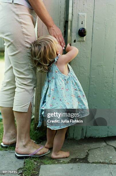 woman helping girl 2 yrs old open door - girl with legs open stock pictures, royalty-free photos & images