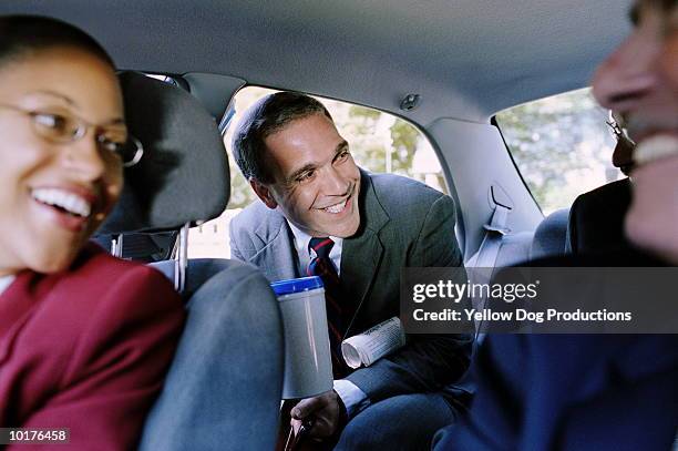 businessman entering car with briefcase - carpool stock pictures, royalty-free photos & images