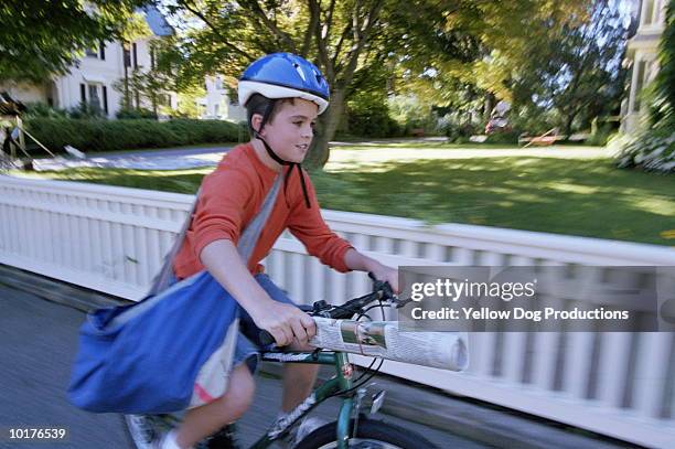 paperboy delivering newspapers on bike - newspaper boy stock pictures, royalty-free photos & images