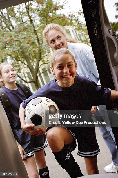 girls going to soccer practice with mom - inside car stockfoto's en -beelden