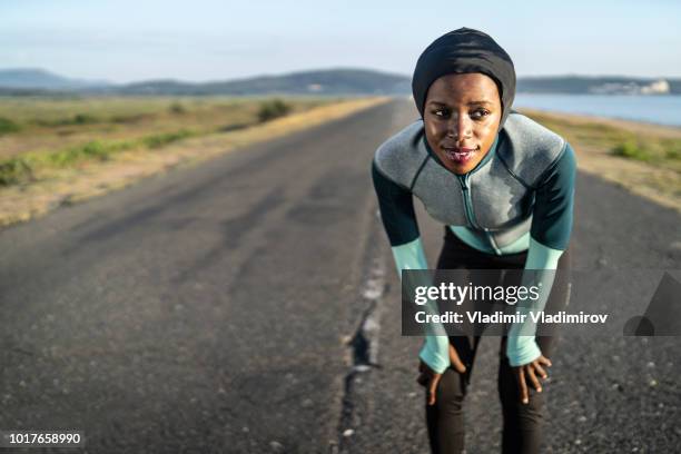 african female runner with hijab - muslim woman beach stock pictures, royalty-free photos & images