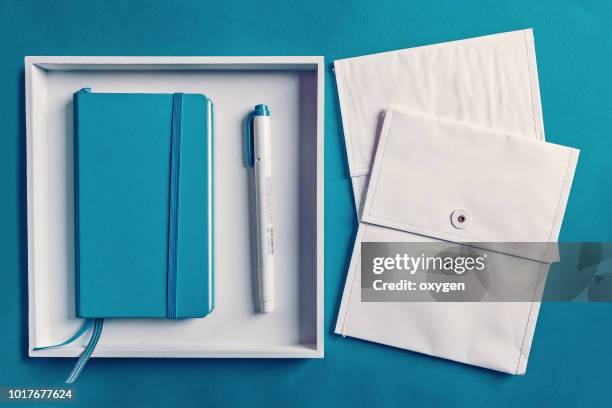 knolling office sets on a blank aqua paper - blue note pad stock pictures, royalty-free photos & images