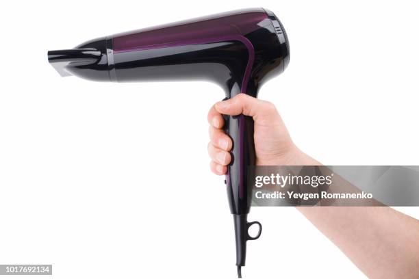 purple hairdryer in hand on a white background - hair dryer foto e immagini stock