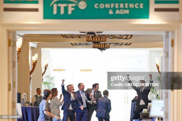 Members of the Kosmos sports group, including founder and Barcelona FC soccer player Gerard Pique celebrate during the ITF annual general meeting in...