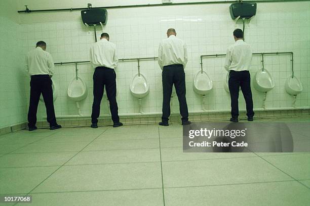 four executives men in restroom - gambe divaricate foto e immagini stock
