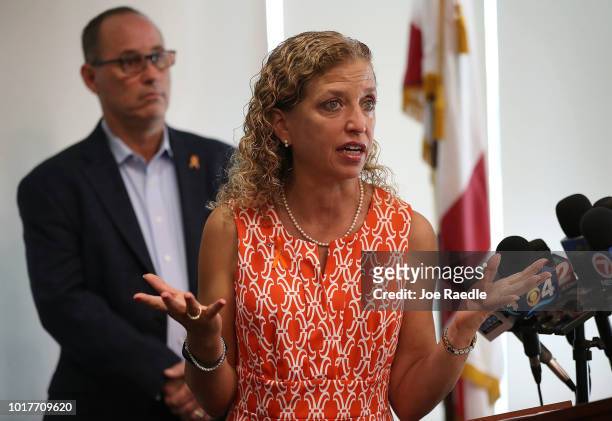 Rep. Debbie Wasserman Schultz speaks as Fred Guttenberg, co-founder of the Orange Ribbons for Jaime, stands behind her during a press conference,...