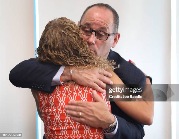 Rep. Debbie Wasserman Schultz is hugged by Fred Guttenberg, co-founder of the Orange Ribbons for Jaime, during a press conference, held at the...