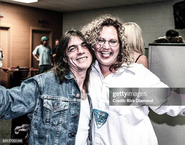 Malcolm Young of AC/DC meets a fan backstage following their performance at The ONMI Coliseum on August 17, 2000 in Atlanta, Georgia.