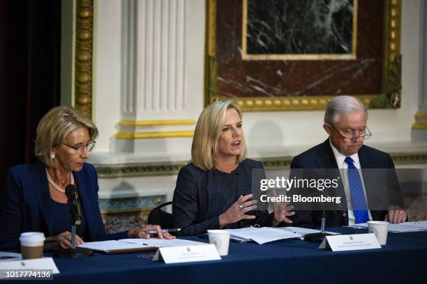 Kirstjen Nielsen, U.S. Secretary of Homeland Security , center, speaks as Betsy DeVos, U.S. Secretary of education, left, and Jeff Sessions, U.S....