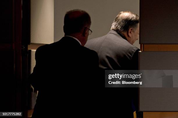 Mike Pompeo, U.S. Secretary of state, right, walks out after speaking in the briefing room at the State Department in Washington, D.C., U.S., on...