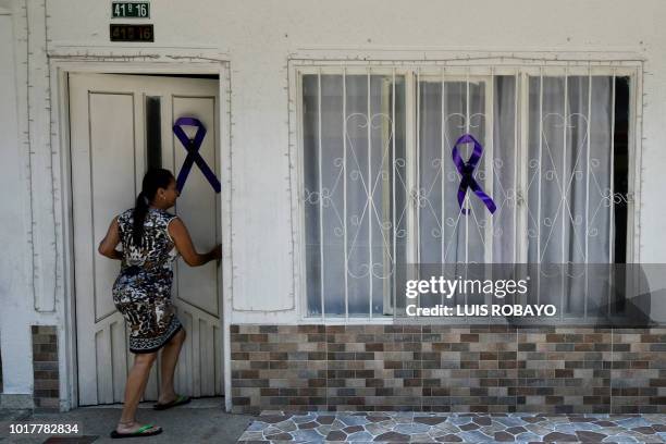 Woman enters a house where one of the 19 Colombian victims involved in a bus accident in Ecuador, that left 24 dead, lived in Cali, Colombia on...