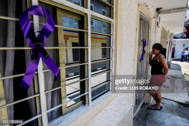 Violet ribbons hang outside the house of one of the 19 Colombian victims, involved in a bus accident in Ecuador, in Cali, Colombia on August 16,...