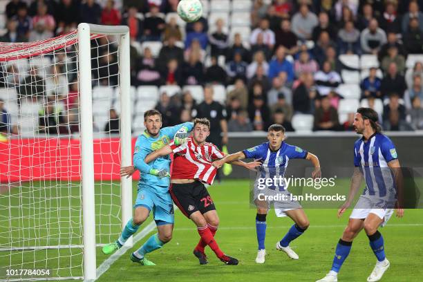 Elliot Embleton of Sunderland gets in a tangle with Wednesday keeper Joe Wildsmith during the Carabao Cup First Round match between Sunderland and...