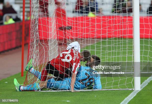 Elliot Embleton of Sunderland gets in a tangle with Wednesday keeper Joe Wildsmith during the Carabao Cup First Round match between Sunderland and...