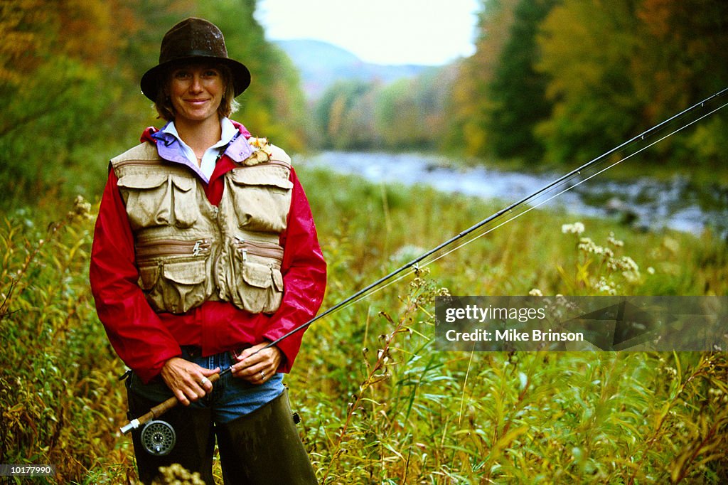 WOMAN FLYFISHER IN AUTUMN, PORTRAIT