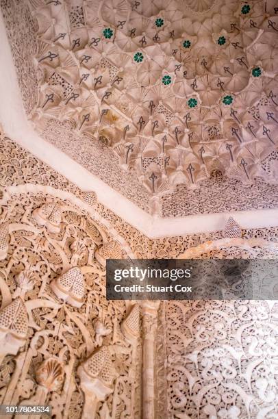 ornate carved stone and marble panelling and ceilings are common in the many historic buildings of the bahia palace in marrakech - bahia palace stock pictures, royalty-free photos & images