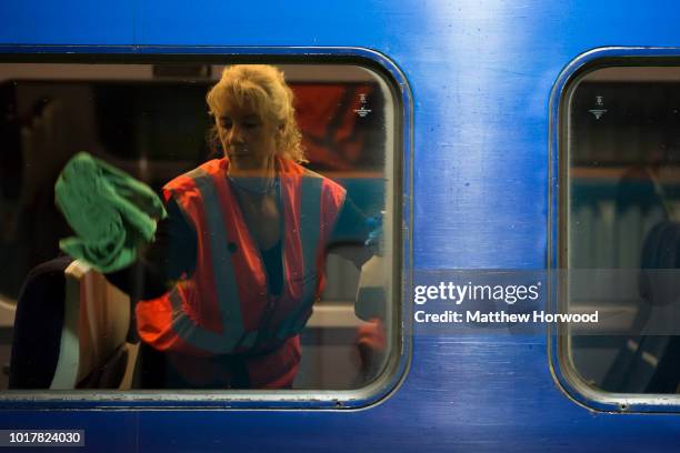 Cleaner cleans the window of a train at the Arriva Trains Wales Canton Diesel Depot in Leckwith on September 12, 2016 in Cardiff, United Kingdom. A...