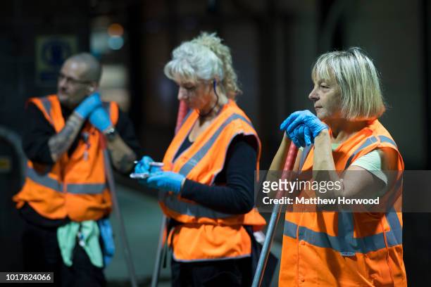 Cleaners stand on a platform waiting for the next train at the Arriva Trains Wales Canton Diesel Depot in Leckwith on September 12, 2016 in Cardiff,...