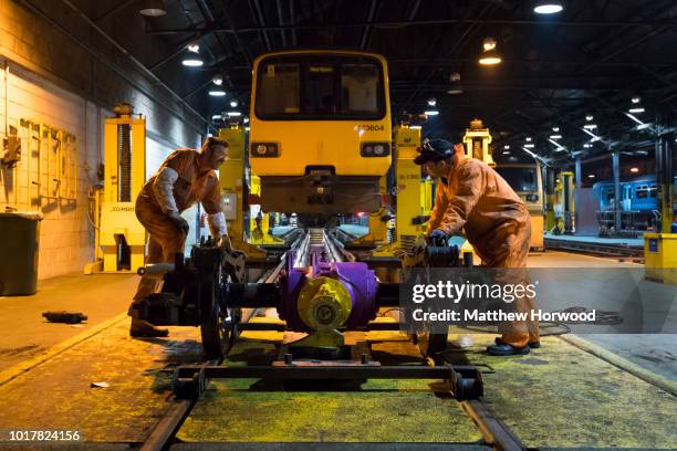 Engineers at work under the carriage of a train at the Arriva Trains Wales Canton Diesel Depot in Leckwith on September 12, 2016 in Cardiff, United...