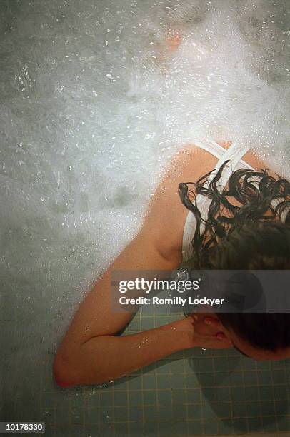 woman relaxing in hot tub/spa - balneotherapy stock pictures, royalty-free photos & images