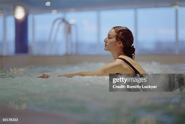 woman in hot tub/spa - balneotherapy stock pictures, royalty-free photos & images