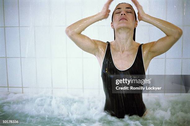 woman in hot tub/spa - balneotherapy stock pictures, royalty-free photos & images
