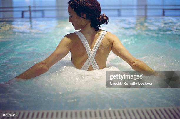 woman in hot tub/spa - balneotherapy stock pictures, royalty-free photos & images