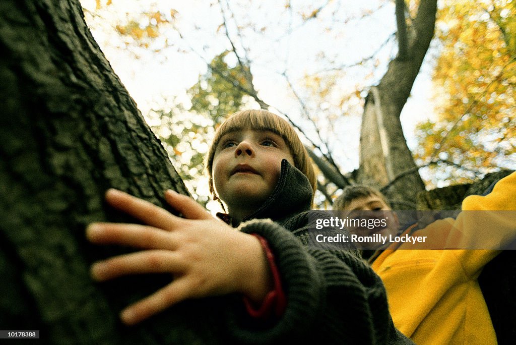 TWO BOYS OUTDOORS IN FALL, ENGLAND