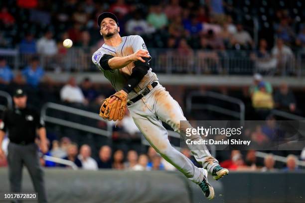 Nolan Arenado of the Colorado Rockies throws to first for an out during the eighth inning against the Atlanta Braves at SunTrust Park on August 16,...