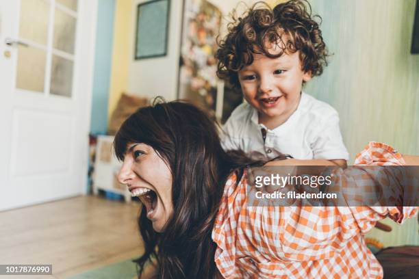 mother and son having fun at home - nanny stock pictures, royalty-free photos & images