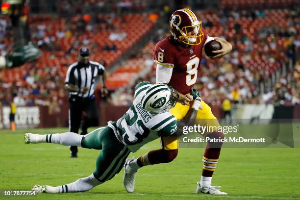 Quarterback Kevin Hogan of the Washington Redskins is tackled by defensive back Terrence Brooks of the New York Jets in the second half of a...