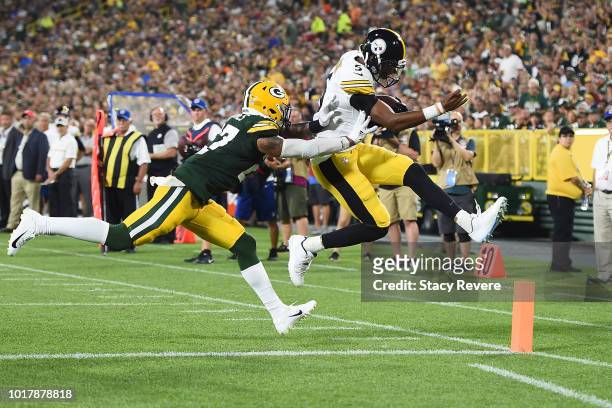 Joshua Dobbs of the Pittsburgh Steelers avoids a tackle by Josh Jones of the Green Bay Packers to score a two point conversion during the third...