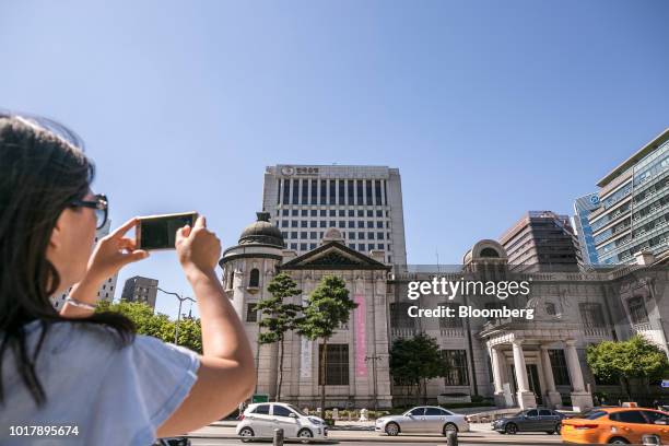Woman takes a photograph outside the Bank of Korea museum at the central bank's headquarters in Seoul, South Korea, on Thursday, Aug. 16, 2018. While...