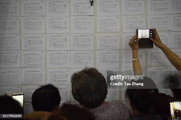 Elderly people view marriage-seeking leaflets during a blind date event for Chinese valentine's day on August 17, 2018 in Harbin, China.More and more...