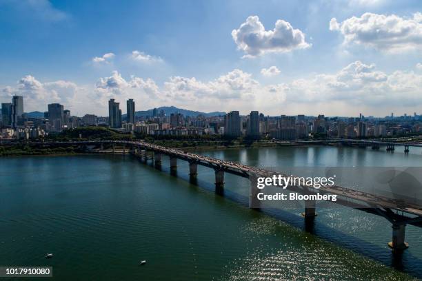 Vehicles cross a bridge as buildings stand in the background in this aerial photograph taken in Seoul, South Korea, on Saturday, Aug. 11, 2018. South...