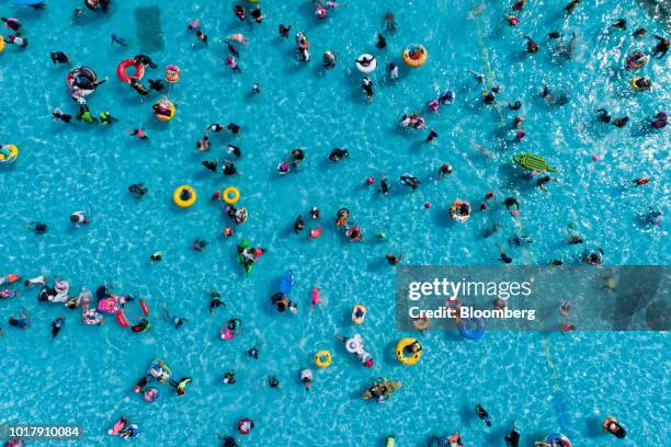 People bathe in a swimming pool at Ttukseom Hangang Park in this aerial photograph taken in Seoul, South Korea, on Saturday, Aug. 11, 2018. South...