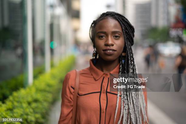 portrait of african woman at street - in the center stock pictures, royalty-free photos & images